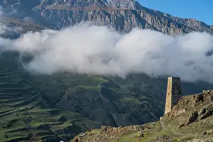 Terrain Prints: Old watchtower stands tall against mountains and clouds in North Ossetia, Russia