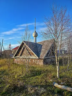 Season Prints: Old wooden house in a rural area near a tower in Russia