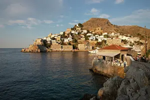 Dining Prints: Omilos Restaurant Bar and whitewashed houses on hillside behind in evening