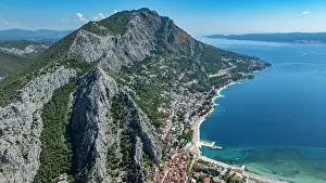 Trekking Prints: Omis coast features rocky mountains and clear water in Croatia near the town and beach