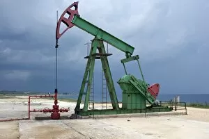 An on-shore oil pump along the coast east of Havana, Cuba, West Indies, Central America