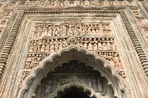 Terra Cotta Prints: Ornate terracotta carvings of Hindu gods over the arched entrance to the Pratapeswar Temple