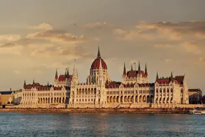Orszaghaz Parliament neo-Gothic building and River Danube view at sunset, with clouds above, UNESCO World Heritage Site, Budapest, Hungary, Europe