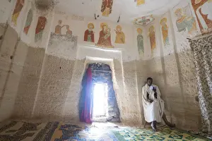 Priest Prints: Orthodox Christian priest holding the prayer book inside Daniel Korkor church