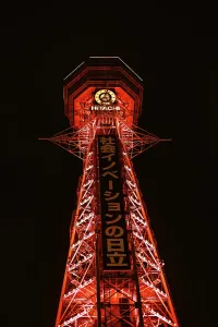 Nightlife Prints: Osaka Tsutenkaku tower in the Shinsekai district. Illuminated red night lights. Japan