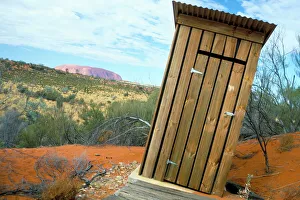 Images Dated 25th July 2008: Outback dunny and Uluru (Ayers Rock), Uluru-Kata Tjuta National Park, Northern Territory