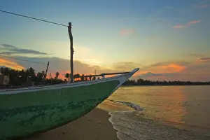 Eastern Province Prints: Outrigger boat at sunset at this fishing beach and popular tourist surf destination
