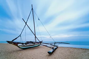 Sri Lanka Prints: Outrigger fishing boat on Negombo Beach at sunrise, Sri Lanka, Asia