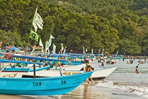 Outrigger fishing boats on west beach of the isthmus at this major beach resort on the south coast, Pangandaran, Java, Indonesia, Southeast Asia, Asia