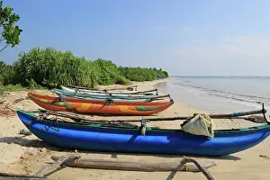 Nets Prints: Outrigger fishing canoes on tropical beach at Pasikudah Bay