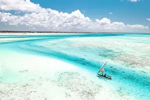 Sailboat Prints: Overhead view of tourist boat on coral reef in the exotic lagoon