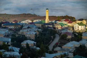 Overlook Prints: Overlook of Kubachi town in Dagestan with a view of houses and a tower among mist