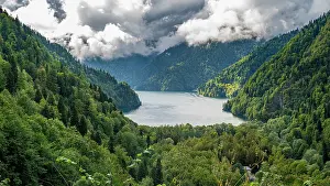Fresh Prints: Overlook of Ritsa lake in Ritsa Relict National Park showcasing lush green forests and cloudy skies in Russia
