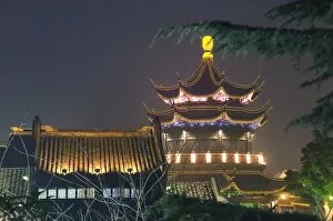 Pagoda and traditional architecture illuminated at night in Shantang water town