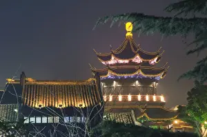 Radiant Prints: Pagoda and traditional architecture illuminated at night in Shantang water town