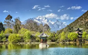 Pagodas with Yu Long Xue Shan (Jade Dragon Snow Mountain) in Jade Spring Park in spring, Lijiang, Yunnan, China, Asia
