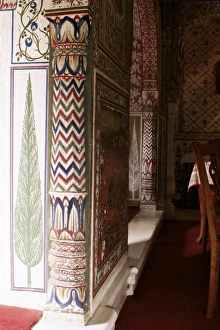 Detail of painted column and cypress tree in dining