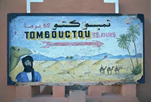 Painted road sign pointing in the direction of Tombouctou (Timbuktu)