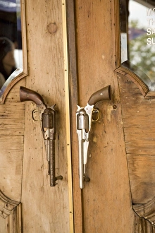 Texas Prints: A pair of guns on doorway to restaurant in Houston, Texas, United States of America