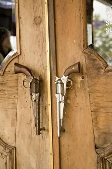 A pair of guns on doorway to restaurant in Houston, Texas, United States of America