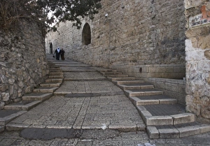 Israeli Prints: Two Palestinian women walking down a street along the city walls