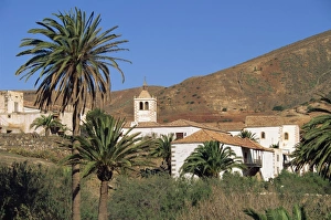 Palm trees, houses and church at Betancuria, on Fuerteventura in the Canary Islands
