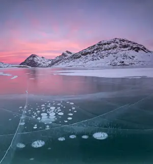 Engadine Prints: Panorama of ice bubbles and frozen surface of Lago Bianco at dawn, Bernina Pass