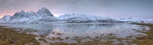 Pink Sky Prints: Panorama of pink sky at dawn on snowy fields and wooden hut surrounded by frozen sea