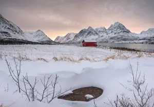 Winter Scene Prints: Panorama of pink sky at dawn on the wooden hut surrounded by frozen sea and snowy peaks