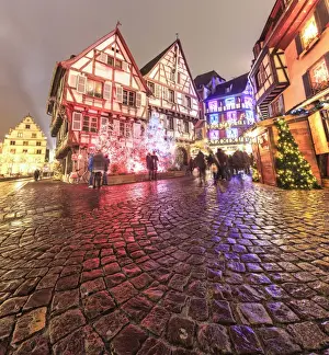 Christmas Tree Prints: Panorama of typical houses enriched by Christmas ornaments and lights at dusk, Colmar