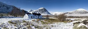 Panoramic view of Black Rock Cottage with Buachaille Etive Mor in distance on snow covered Rannoch Moor, near Fort William, Highland, Scotland, United