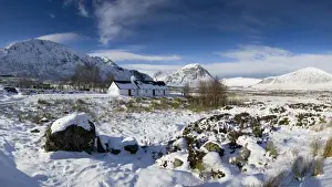 Panoramic view of Black Rock Cottage with Buachaille Etive Mor in distance on snow covered Rannoch Moor, near Fort William, Highland, Scotland, United
