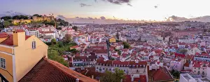 Alfama Prints: Panoramic view of Lisbon Castle from Miradouro da Senhora do Monte scenic point at dusk in the Alfama District