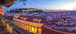 Alfama Prints: Panoramic view of Lisbon Castle from Miradouro da Senhora do Monte scenic point at dusk in the Alfama District