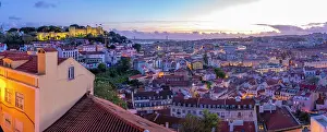 Alfama Prints: Panoramic view of Lisbon Castle from Miradouro da Senhora do Monte scenic point at dusk in the Alfama District