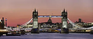 Panoramic view of Tower Bridge framing St. Pauls Cathedral at dusk, London, England