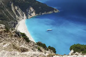 Myrtos Beach Prints: Panoramic view of world famous Myrtos beach with crystal clear waters and moored yacht in Kefalonia island