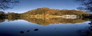 Panoramic winter view across Loughrigg Tarn with reflections, near Ambleside