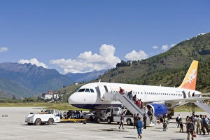 Passenger plane at Paro International Airport, Paro Rinpung Dzong in the distance Passenger plane at Paro International Airport, Paro Rinpung Dzong in the distance