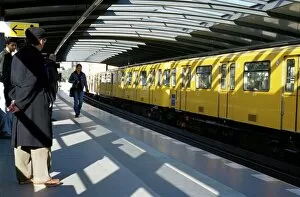 Images Dated 30th July 2008: Passengers on the platform and a yellow train