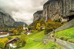 Fence Prints: Path in the autumn landscape of Lauterbrunnen village towards Trummelbach Falls