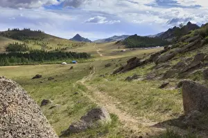 Central Mongolia Prints: Path winds past hills and tourist ger camp towards distant mountains in summer, Terelj