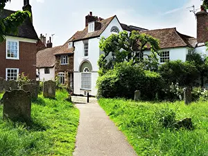 Cemetery Prints: Pathway leading through St Marys Churchyard with historic buildings and greenery in Rye