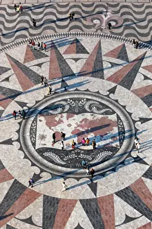 Aerials Prints: Pavement map showing routes of Portugese explorers below Monument to the Discoveries