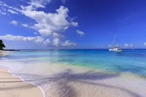 Paynes Bay, small boats off fine pale pink sand beach, turquoise sea