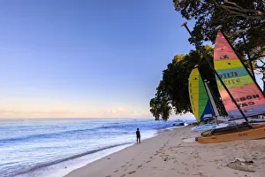 Barbados Prints: Paynes Bay at sunrise, lady exercises on beach, colourful sail boats