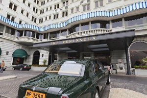 The Peninsula Hotel and one of the hotels fleet of green Rolls Royces