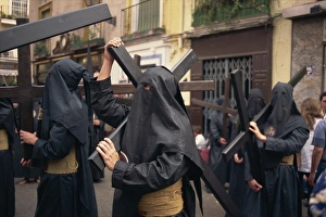Holy Week Prints: Penitents bearing crosses in procession, Holy Week (Semana Santa), Seville