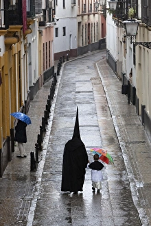 Costumes Prints: Penitents during Semana Santa (Holy Week) along rainy street