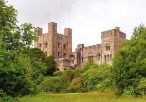 Gwynedd Prints: Penrhyn Castle stands amid greenery in Wales showcasing its historic architecture and structure